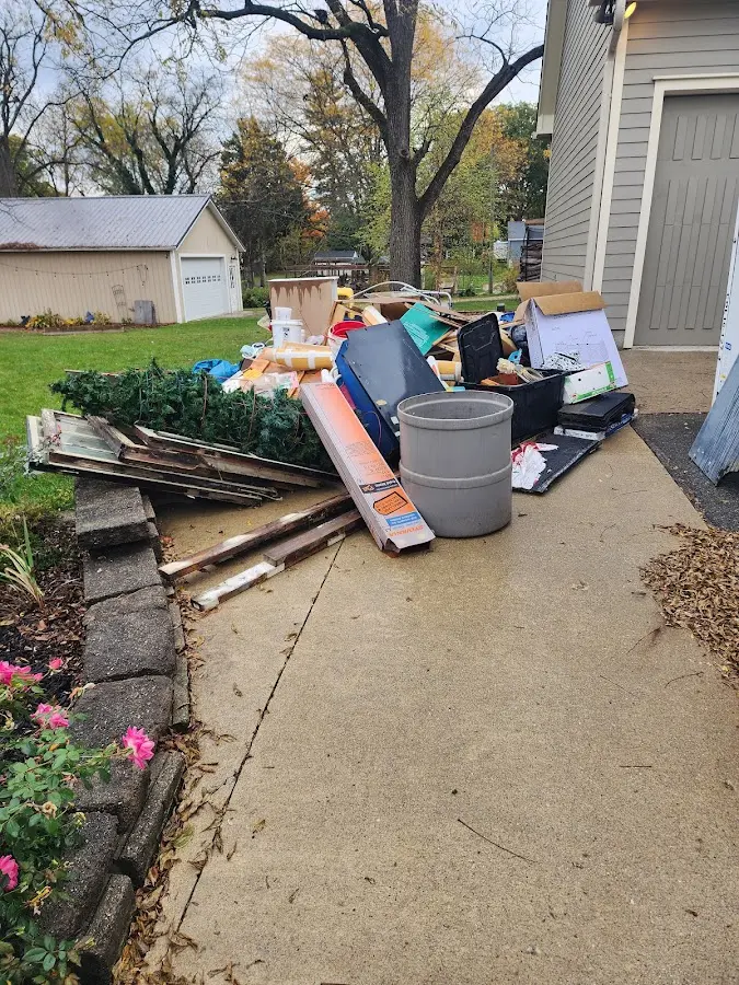Dumpster being loaded with debris for Roofing Dumpster Rental in Tallassee
